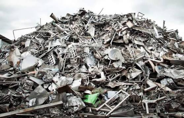 A large pile of sorted scrap metal at a recycling yard